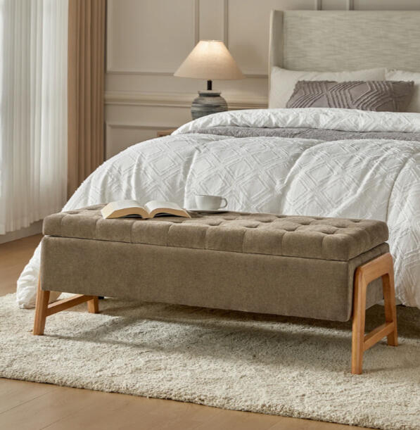 Upholstered storage bench at the foot of a bed. Tufted, simple, elegant, with a mid-century feel.