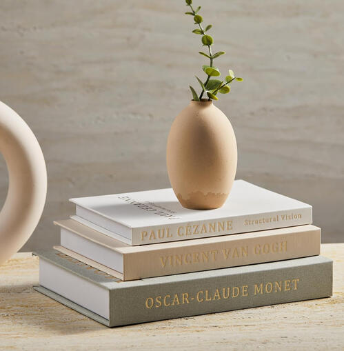 Neutral decorative book stack with hidden storage compartment, simple styling piece for nightstand or shelf.
