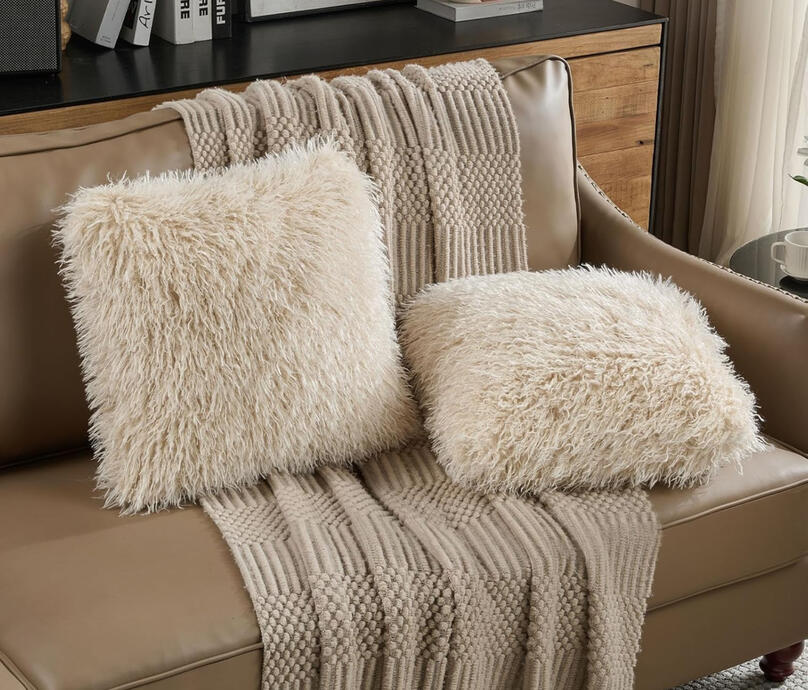Add volume and dimension — quintessential mid-century texture. Long-pile faux wool pillow in creamy ivory, perfect for adding warmth and texture to a mid-century bedroom.
