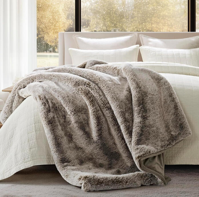 Thick faux rabbit fur blanket with variegated texture in soft neutrals. Adds plush mid-century luxury and inviting warmth to the room.