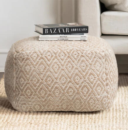 Neutral cotton pouf with textured stitching and eco-friendly filling.