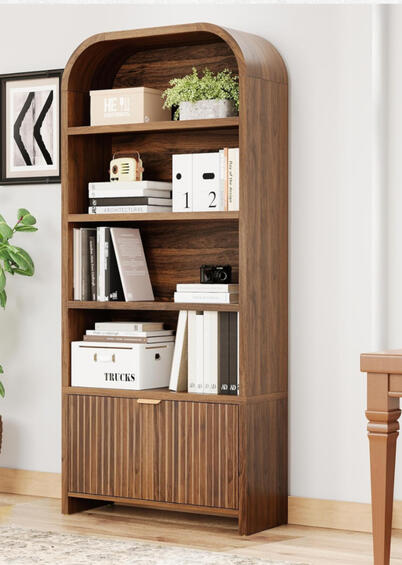 Walnut arched bookshelf with fluted detailing, brass drawer handle, and open shelves styled with books and décor. Warm mid-century design that complements walnut or light oak bedrooms.